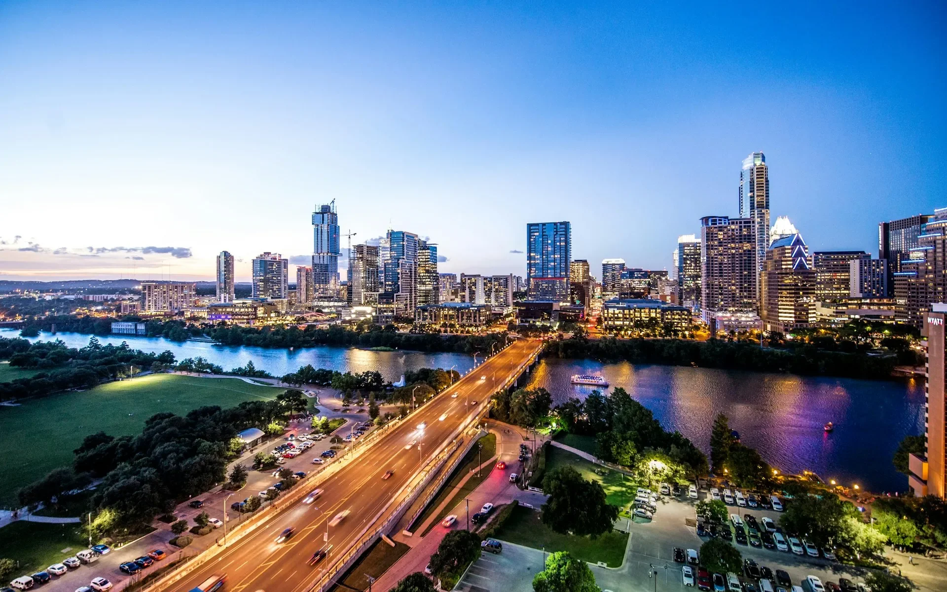 Austin Texas skyline at dusk showing downtown, Congress Avenue bridge, and Lady Bird Lake - Austin Locksmiths service areas